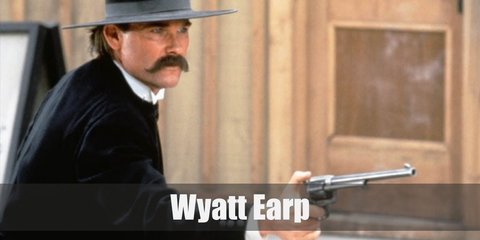  Wyatt Earp’s outfit is reminiscent of the respectable wear men don on in the Old West. He wears white dress shirt underneath a black vest, black pants, black coat, and black boots.  