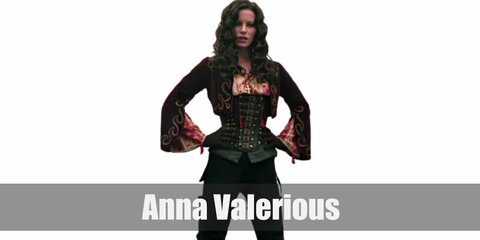 Anna Valerious’ costume is a white Victorian blouse cinched with a black waist corset, a red cropped jacket, tight black jeans, black boots, and a gold cross necklace.
