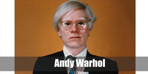  Andy Warhol’s costume is  a black long-sleeved turtleneck shirt, grey jeans, a black leather belt, black Chelsea boots, and clear fashion glasses.