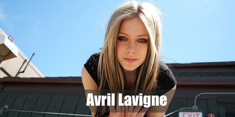  Avril Lavigne’s costume is a full cover black lace bra, a black high waist brief with white garter, a crop sleeveless white tank top, wide-leg army pants, black sneakers, a striped navy blue tie, and punk studded bracelets.