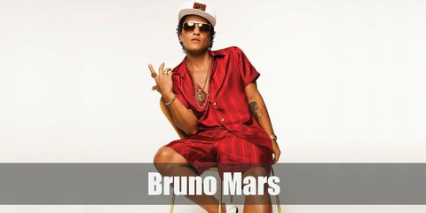 Bruno Mar's iconic costume features a matching red top and shorts styled with gold accessories, white hat, and loafers.