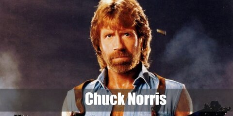 Chuck Norris’s costume is a sleeveless blue denim button-down shirt, relaxed-fit blue jeans, brown Chelsea boots, and a black belt with a large buckle.