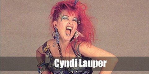  Cyndi Lauper’s costume is a black party dress, black fishnet leggings, lace-up black booties, black glovelets, a chain belt, a necklace, wristlets, fancy silver bracelets, assorted ankle bracelets, and colorful 80s rocker hair.
