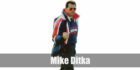 Mike Ditka isa legendary coach who wore his Chicago Bears top over a long-sleeved white shirt and necktie. He wears dark pants and white shoes, too.