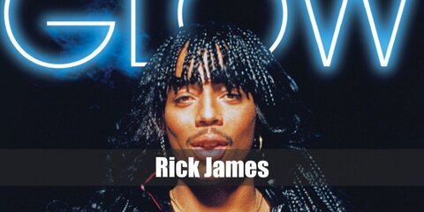 Rick James' costume features a black leather top and bottom paired with red boots. He has braided hair, too. 