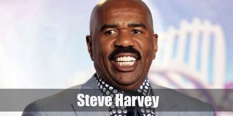 Steve Harvey's costume features an all-green look complete with a trench coat, shirt, necktie, and pants.