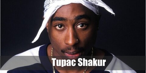Tupac wears his signature bandana with a white shirt,a vest, and a pair of denim pants.