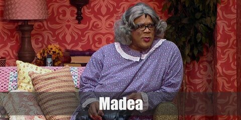  Madea’s costume is a purple dress, black flats, and grey glasses while bringing along a black handbag and pistol.
