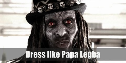  Papa Legba’s whole outfit can be described as intimidating. He wears a white linen button-down, black pants, black boots, a black fur cape, a black top hat, and a voodoo necklace. 