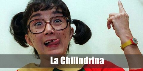  La Chilindrina’s costume is a green dress with a round yellow collar and red sleeves, short white bloomers, white crew socks, t-strap black Mary Jane shoes, her hair in pigtails, and black nerd geek eyeglasses.