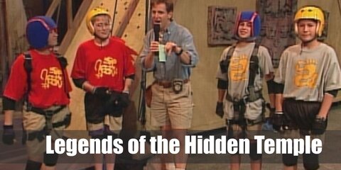 Legends of the Hidden Temple’s costume is  a colored Legends of the Hidden Temple shirt, khaki cargo shorts, brown walking shoes, black elbow and knee pads, black fingerless sports gloves, and a gold helmet.