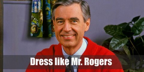 Mr. Rogers costume is a light blue dress shirt, a black patterned tie, a red cardigan, blue pants, and blue sneakers.  