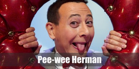 Pee Wee Herman’s outfit is a crisp white dress shirt underneath a grey suit. He also has a red bow tie and a pair of white dress shoes. 
