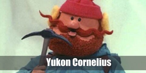  Yukon Cornelius’s costume is a blue climbing coat, blue ski pants, tall black snow boots, a black tactical belt, and a red pomp pom beanie hat.
