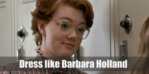 Barbara Holland costume is a simple high-waist mom jeans, brown loafers, a cool plaid top with frills, and an awesome pair of eyeglasses. 