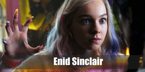  Enid Sinclair’s costume is a long-sleeved classic striped sweater, a colorful floral mini skirt, purple novelty crew socks, yellow high-top canvass shoes, and blonde hair with pink and blue highlights.