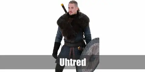  Uhtred costume is a grey long-sleeve shirt, a medieval waist coat, black pants, a fur neck warmer, black boots, black gauntlets, numerous weapons, and a Viking shield.