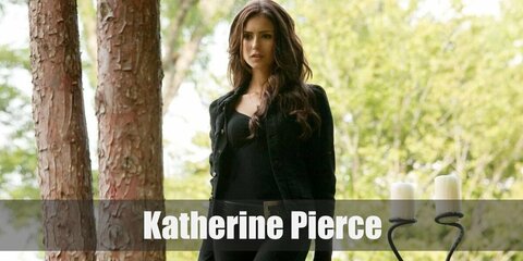 Katherine's costume features an all-black ensemble with a balloon-sleeve top and pants and heels.