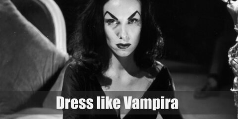  Vampira costume is a skin tight black dress with a plunging neckline and billowing bat-like sleeves. She also wears a nice black waist belt.  