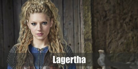  Lagertha’s costume is a blue long-sleeved shirt, chainmail armor, a brown corset, brown pants, a pair of dark boots, arm gauntlets, and a long, braided blonde wig.